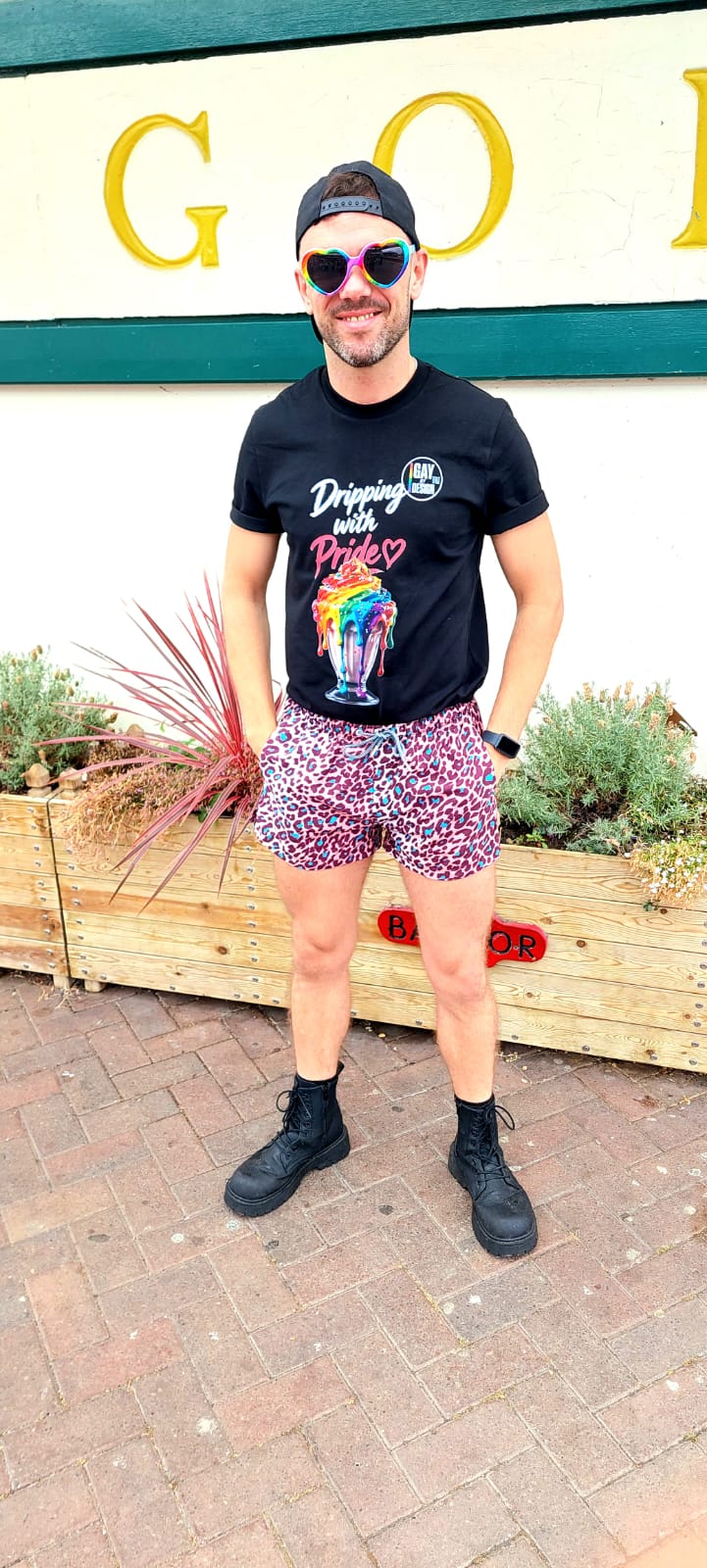 Kenny wearing the Dripping with Pride T-shirt